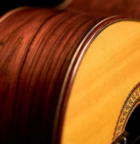 The soundboard, side and binding of a 1996 Tezanos-Perez classical guitar made with Spruce and CSA rosewood