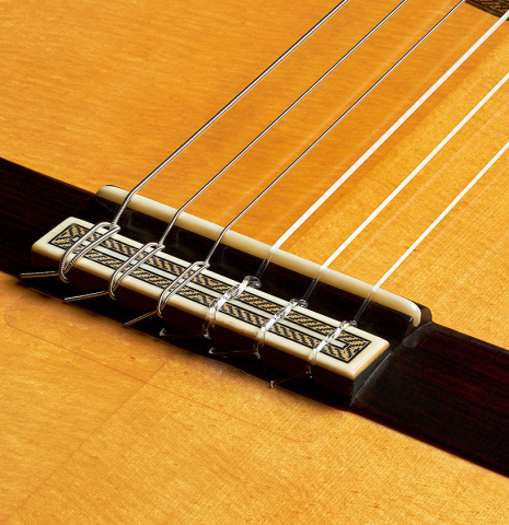 The bridge, tie-block and saddle of a 2002 Tezanos-Perez classical guitar made with Spruce and CSA rosewood