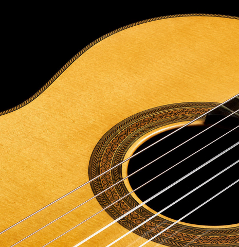 The soundboard and rosette of a 2002 Tezanos-Perez classical guitar made with Spruce and CSA rosewood