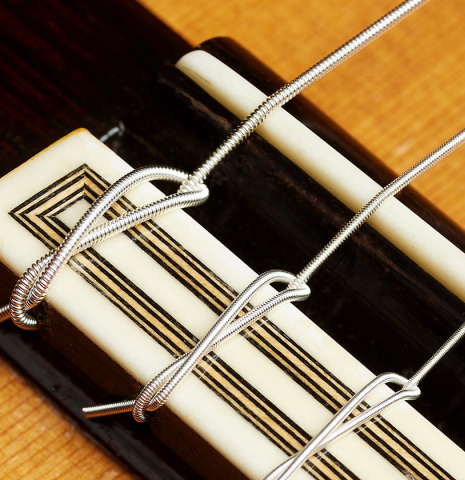 The bridge, tie-block and saddle of a 2002 Tezanos-Perez "Concierto" classical guitar made with cedar and CSA rosewood