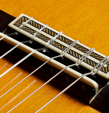 The bridge, tie-block and saddle of a 2006 Mariano Tezanos "Maestro" classical guitar (ex Scott Tennant) made of cedar and CSA rosewood