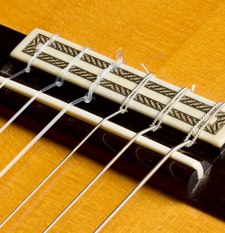The bridge, tie-block and saddle of a 2007 Mariano Tezanos "Maestro" classical guitar made with spruce and CSA rosewood