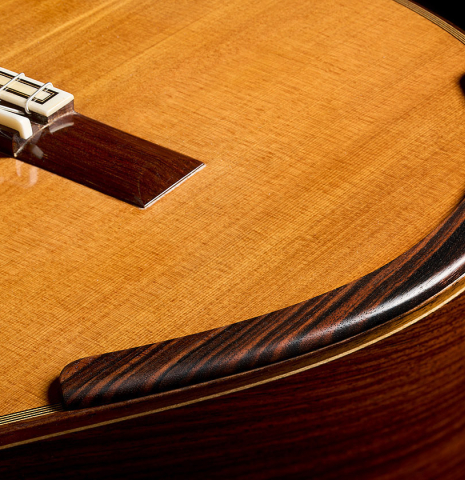The top, side and arm rest of a 2018 Michael Thames classical guitar made of cedar and Indian rosewood