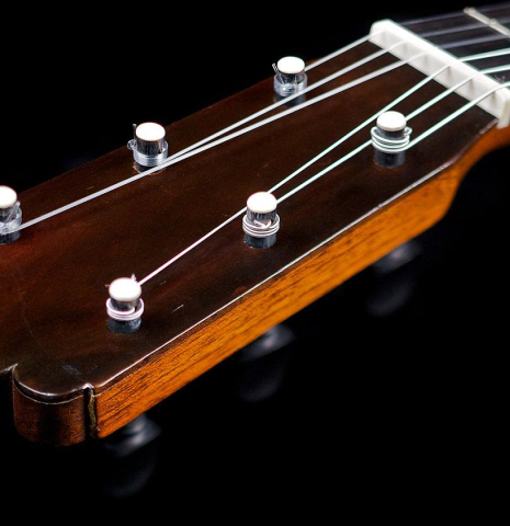 The traditional wooden tuning pegs of an 1886 Antonio de Torres w/pegs classical guitar made of spruce and cypress