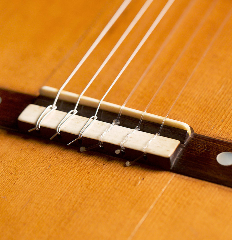 The bridge and nylon strings of Francisco Tarrega's 1888 Antonio de Torres &quot;SE 114&quot; made of spruce and CSA rosewood