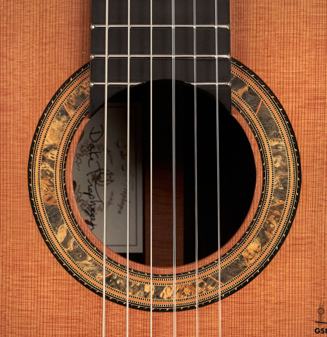 The rosette of a 2016 Dake Traphagen made with cedar and CSA rosewood featuring traditional pegs.