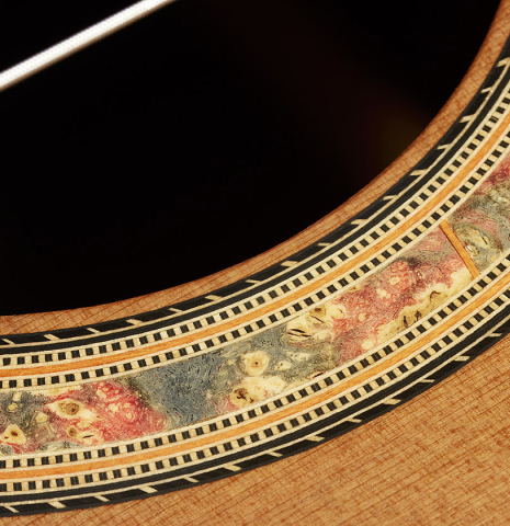Close-up detail of the rosette of a 2023 Dake Traphagen classical guitar made of cedar and CSA rosewood