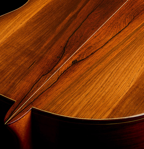 The heel, back binding and purfling of a 1981 Dake Traphagen classical guitar made of spruce and CSA rosewood