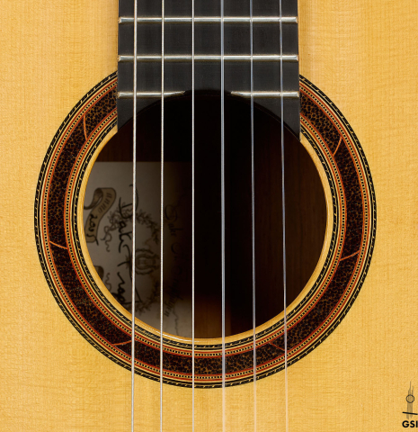 The rosette of a 2005 Dake Traphagen classical guitar made of spruce and African rosewood