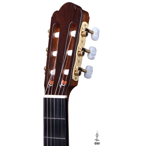 The headstock of a Wataru Tsuji "S-2" SP/IN made with spruce top and Indian rosewood back and sides on a white background