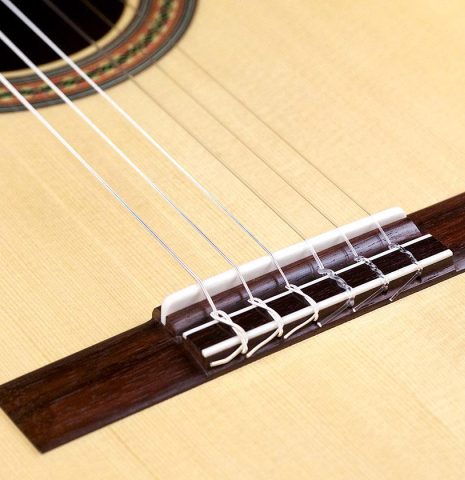 The top, bridge, tie-block and saddle of a Wataru Tsuji "S-2" SP/IN made with spruce top and Indian rosewood back and sides