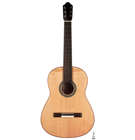 This is the spruce top of a 2020 Mark Usherovich w/pegs classical guitar on a white background.