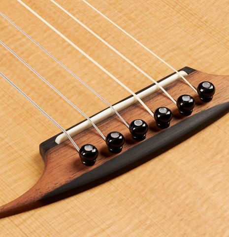 This is the bridge, tie-block and saddle of a 2022 Mark Usherovich "Romantic" classical guitar made with spruce top and maple back and sides