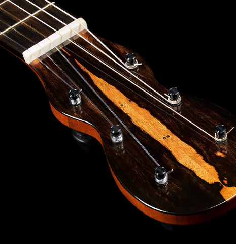 The headstock and machined tuning pegs of a 2024 Mark Usherovich "Romantic" classical guitar made of spruce and maple