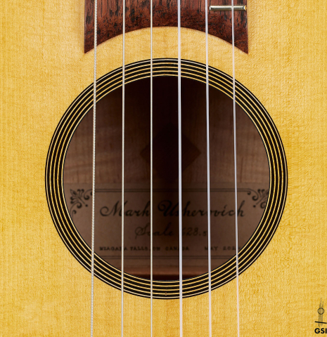 The soundhole of a 2024 Mark Usherovich "Romantic" classical guitar made of spruce and maple