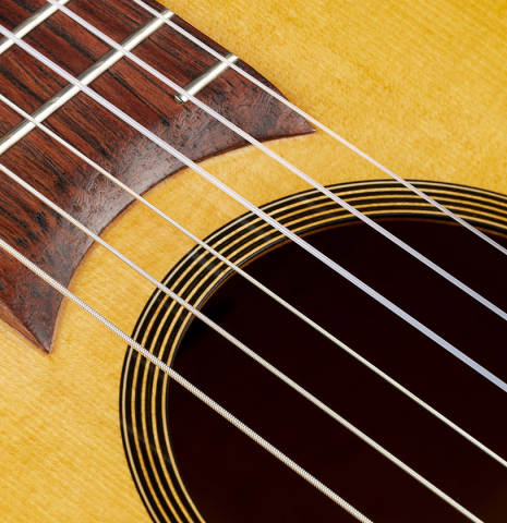 The fingerboard and soundhole of a 2024 Mark Usherovich "Romantic" classical guitar made of spruce and maple