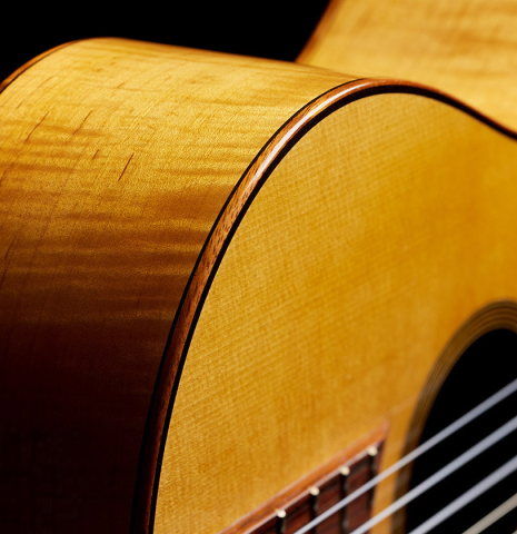 The top and side of a 2024 Mark Usherovich "Romantic" classical guitar made of spruce and maple