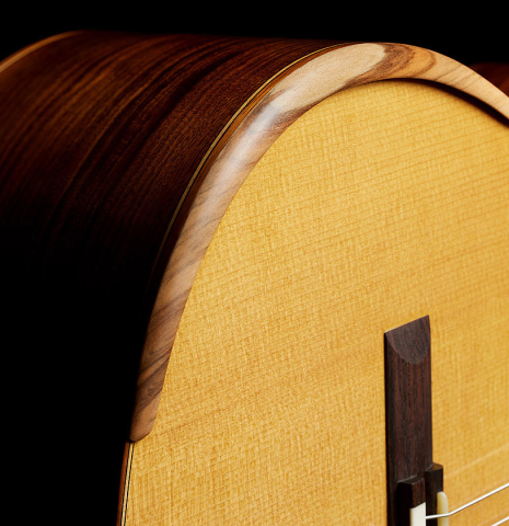 The armrest of a 2023 Mark Usherovich "Lattice" classical guitar made of spruce and pau ferro