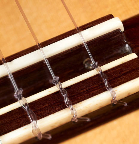 The bridge of a 2006 Manuel Velazquez classical guitar made with spruce and CSA rosewood.