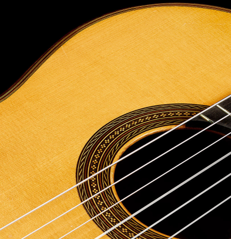 The soundboard and rosette of a 1955 Manuel Velazquez classical guitar made of spruce and CSA rosewood