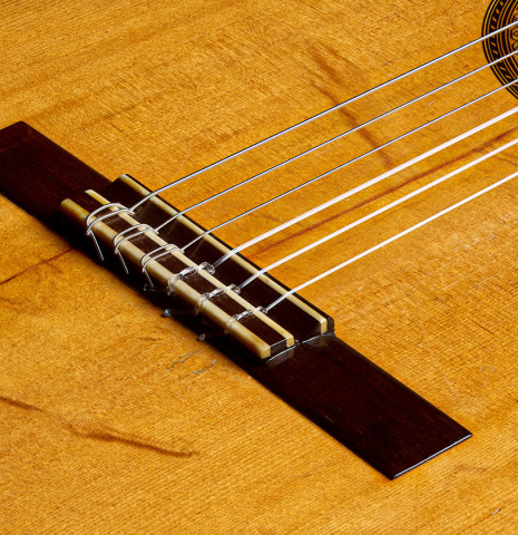 The bridge, tie-block and saddle of a 1958 Manuel Velazquez classical guitar made of spruce and CSA rosewood