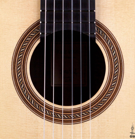 This is the rosette of a Jose Vigil classical guitar built in 2018. It has a spruce soundboard and CSA rosewood back and sides.