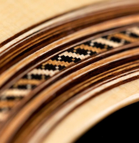 This is a detail of the rosette of a Jose Vigil classical guitar built in 2018. It has a spruce soundboard and CSA rosewood back and sides.
