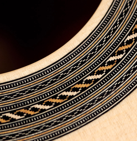 The rosette of a 2022 Jose Vigil classical guitar made of spruce and CSA rosewood.