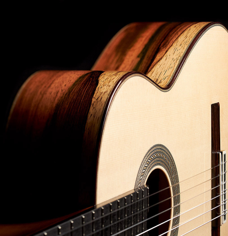 The soundboard and side of a 2022 Jose Vigil classical guitar made of spruce and CSA rosewood.
