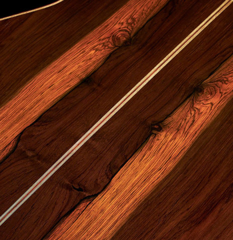 Closeup of the back and center seam of a 2023 Jose Vigil classical guitar made of spruce and CSA rosewood.