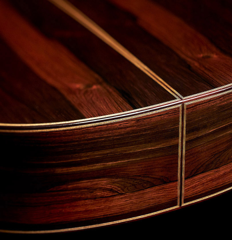 The back and sides at the foot of a 2023 Jose Vigil classical guitar made of spruce and CSA rosewood.