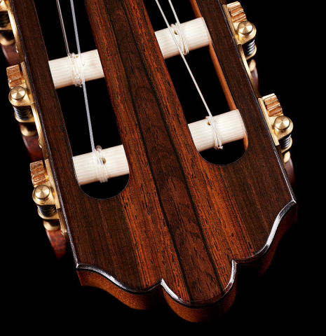 The headstock and tuning machines of a 2024 Jose Vigil classical guitar made of cedar and CSA rosewood.