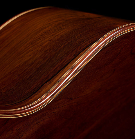 The back binding and purfling of a 2025 Jose Vigil classical guitar made of cedar and CSA rosewood