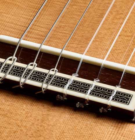 The bridge, tie-block and saddle of a 2025 Jose Vigil classical guitar made of cedar and CSA rosewood