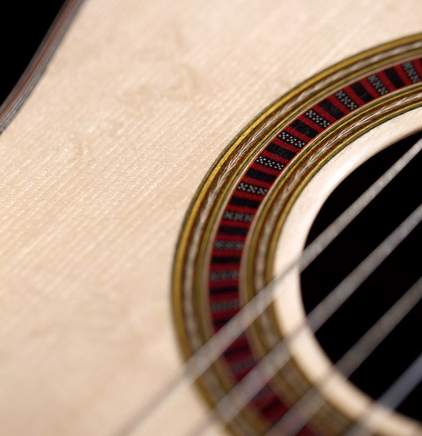 The soundboard and rosette of a 2022 Otto Vowinkel classical guitar made with spruce soundboard and CSA rosewood.