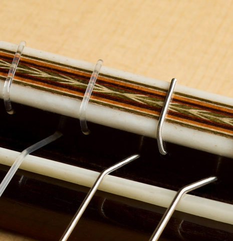The bridge, tie-block and saddle of a 2026 Otto Vowinkel classical guitar made of spruce and CSA rosewood