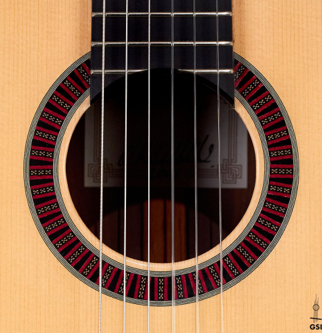 The rosette of a 2001 Otto Vowinkel 640 scale classical guitar made of spruce and CSA rosewood