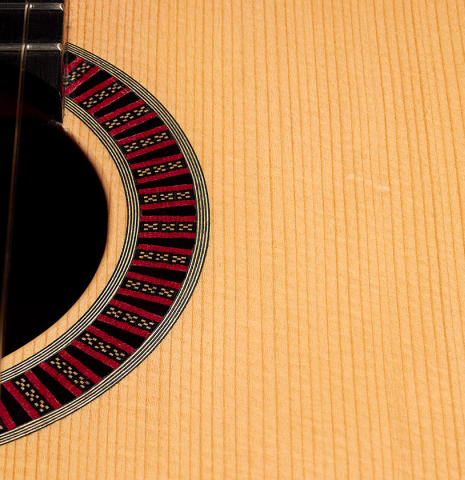 The rosette of a 2001 Otto Vowinkel 640 scale classical guitar made of spruce and CSA rosewood