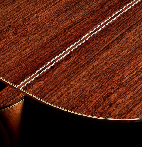 The heel and back binding of an Otto Vowinkel "2a Baritone" classical guitar made with spruce top and Indian rosewood back and sides.