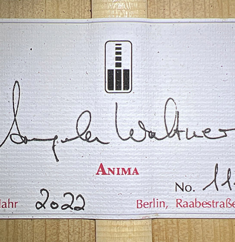 The label with of a 2022 Angela Waltner classical guitar on a white background.