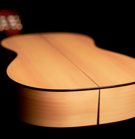 The cypress back and bottom side of a 2022 Angela Waltner classical guitar.