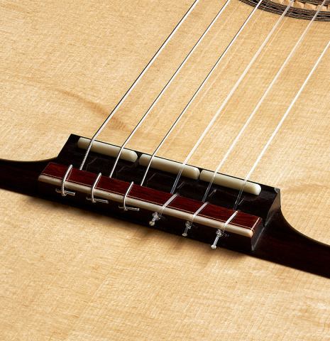 The bridge of a 2023 Angela Waltner "Anima" classical guitar made of spruce and maple