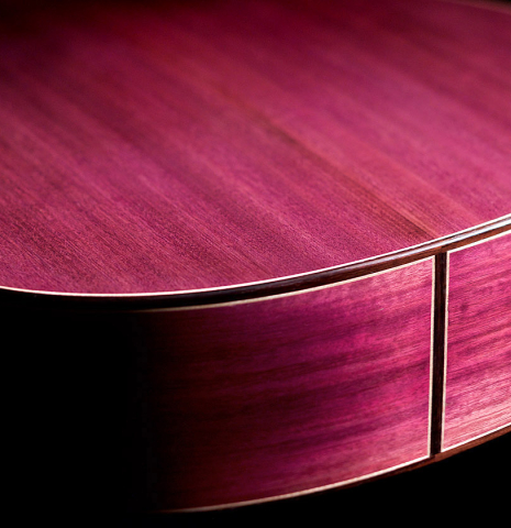 The back and sides of a 2022 Julia Wenzel classical guitar made of cedar and purpleheart wood