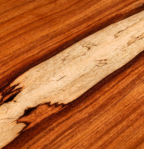 A close-up of the back of a 2022 Julia Wenzel classical guitar made of spruce and granadillo