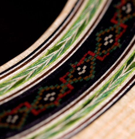A close-up of the rosette of a 2022 Julia Wenzel classical guitar made of spruce and granadillo