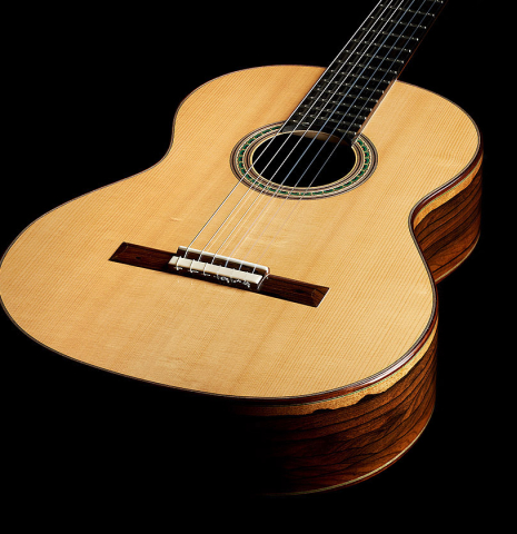 The soundboard of a 2024 Julia Wenzel classical guitar made of spruce and ziricote