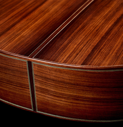 The back and sides at the foot of a 2026 Julia Wenzel classical guitar made of cedar and Indian rosewood