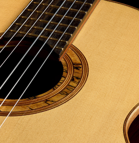 The soundboard and rosette of a 2023 Ken Whisler classical guitar made of spruce and Indian rosewood