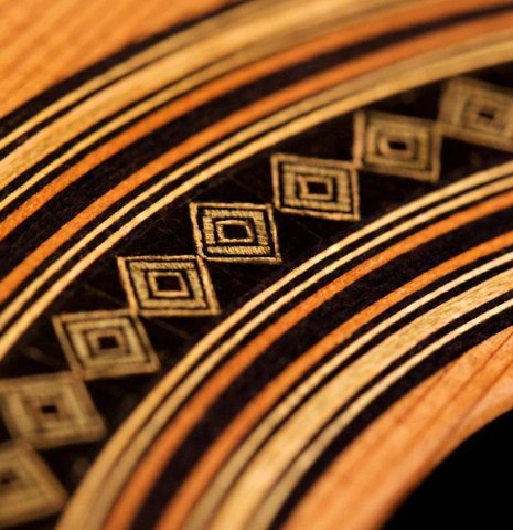 A close-up of the rosette of a 2019 Dominik Wurth classical guitar made of cedar and Indian rosewood
