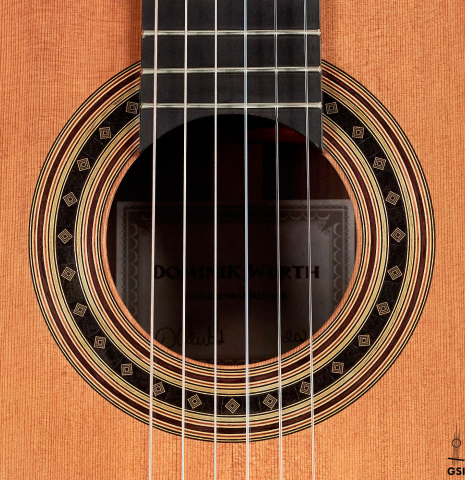 The rosette of a 2022 Dominik Wurth classical guitar made with cedar and Indian rosewood
